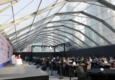 a group of people sitting in a room with a large roof