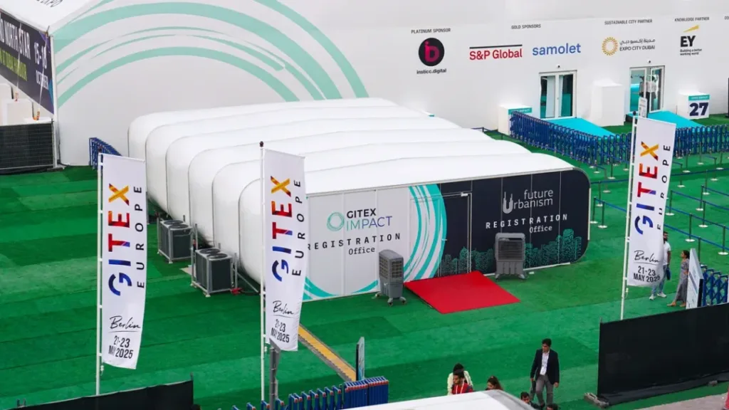 a group of tents on a green field