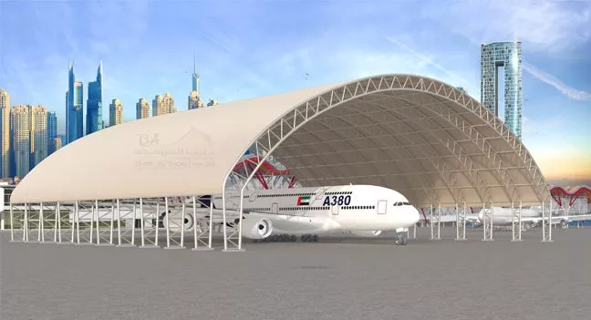a white airplane under a Tent